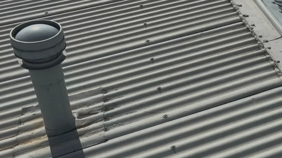 Unused chimney on corrugated iron roof requiring removal in Pukehangi