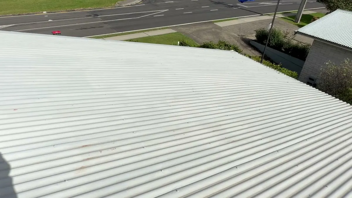 New ridge cap installation and chimney hole patching on corrugated iron roof
