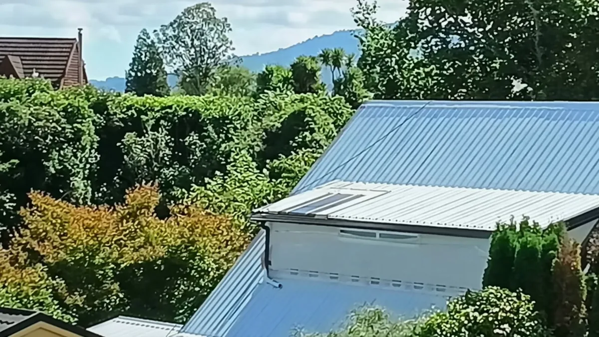Rust treatment and charcoal tape crack remediation on corrugated roof sheets