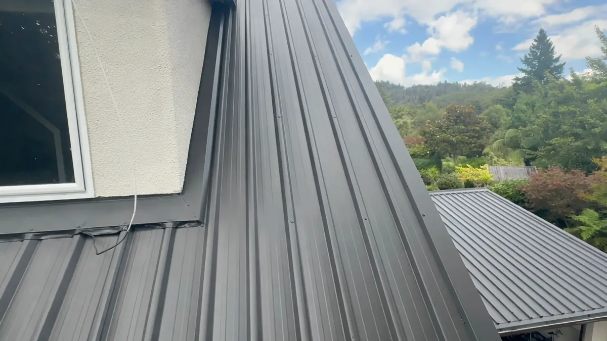 Flaxpod top coats applied after galvanized primer on steep corrugated roof